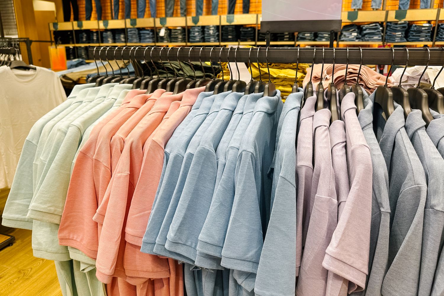 pastel coloured clothes on a rack